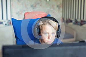 Teenage boy playing computer games on PC