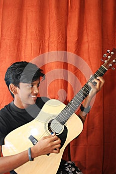 Teenage boy playing guitar