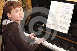 Teenage boy plays piano