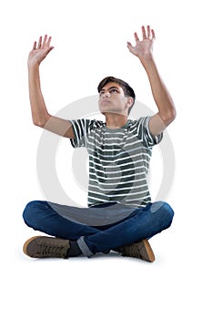 Teenage boy praying against white background