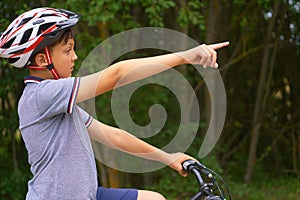 Teenage boy in protective helmet standing over my bike and showing the waypoints.