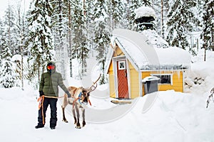 Teenage boy and reindeer in Lapland