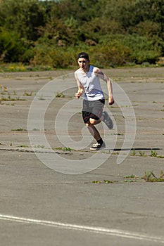 Teenage boy running outside