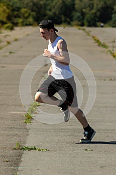 Teenage boy running outside