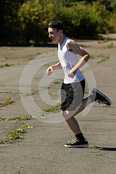 Teenage boy running outside