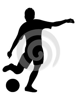 Teenage boy silhouette playing football and going to kick the ball with his foot