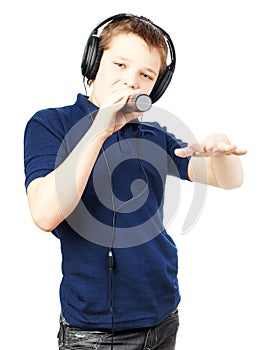 Teenage boy singing into a microphone and gesticulates with a hand. Very emotional