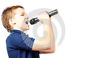 Teenage boy singing into a microphone. Very emotional