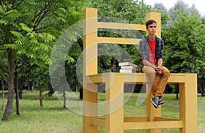 Teenage Boy Sitting on a Big Chair