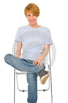 Teenage boy sitting on chair