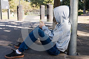 Teenage boy sitting with smart phone