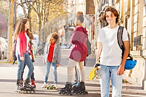 Teenage boy with skateboard at city street