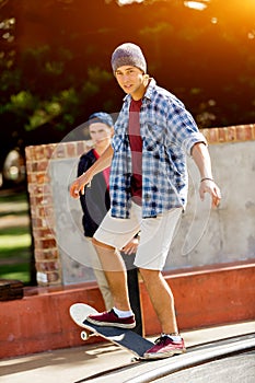 Teenage boy skateboarding outdoors