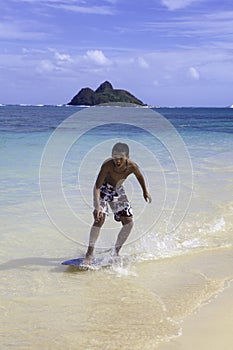 Teenage boy on skim board