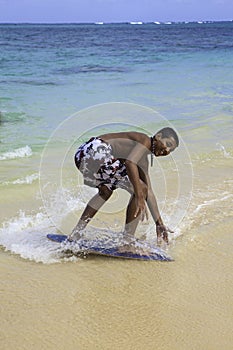 Teenage boy on skim board photo