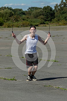 Teenage boy skipping with a skipping rope