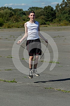 Teenage boy skipping with a skipping rope