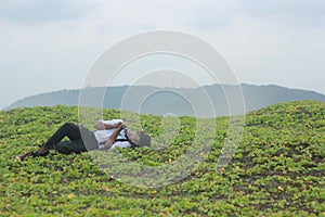 Teenage boy sleeping on grass