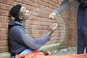 Teenage Boy Sleeping On The Street Being Given Money