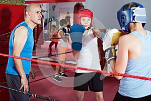 Teenage boy sportsman at boxing workout with coach
