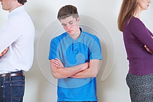 Teenage Boy Standing Between Parents Who Are Ignoring Each Other