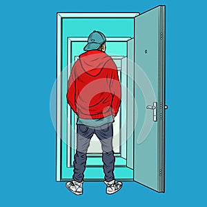 A teenage boy stands on the threshold of an open door