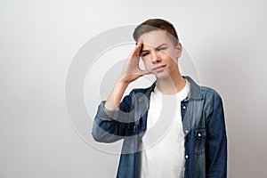 Teenage boy stressed and having headache