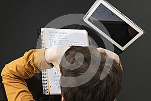 Teenage boy studying with digital tablet at home