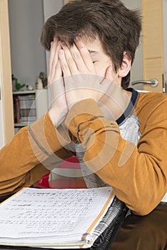 Teenage boy studying with digital tablet at home