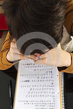 Teenage boy studying with digital tablet at home