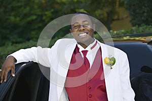 Teenage Boy in suit leaning on limo portrait