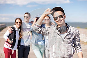Teenage boy with sunglasses and friends outside