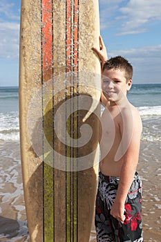 Teenage boy with surfboard