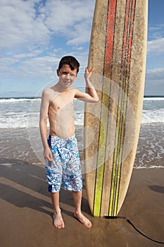 Teenage boy with surfboard