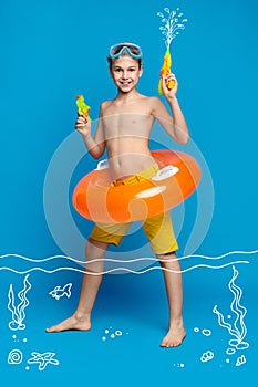 Teenage boy swimming in water with water guns and inflatable ring