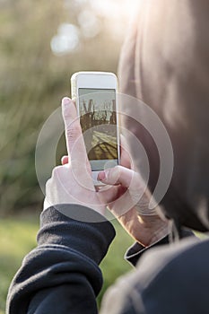 Teenage boy taking photographs