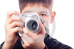 Teenage boy taking photos with small camera