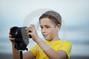 Teenage boy taking pictures with digital camera