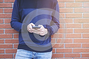 Teenage boy texting message in outside