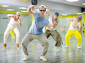 Teenage boy training breakdance Toprock moves in dance hall