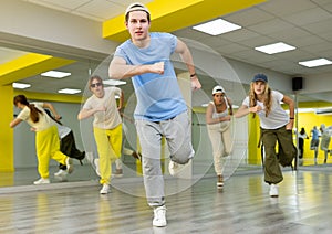 Teenage boy training breakdance Toprock moves in dance hall