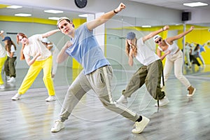 Teenage boy training breakdance Toprock moves in dance hall