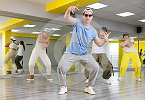 Teenage boy training breakdance Toprock moves in dance hall