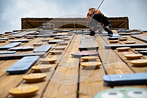 Teenage boy training on climbing wall, bottom view. (Palestra) photo