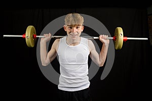 Teenage boy using a barbell