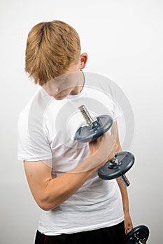 Teenage boy using a dumbbell