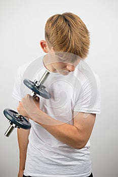 Teenage boy using a dumbbell