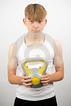 Teenage boy using a kettlebel