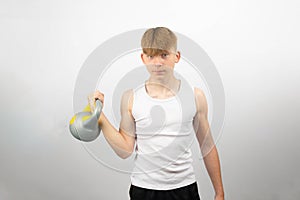 Teenage boy using a kettlebel