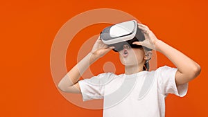 Teenage boy in virtual reality glasses enjoying 3D gadget technology